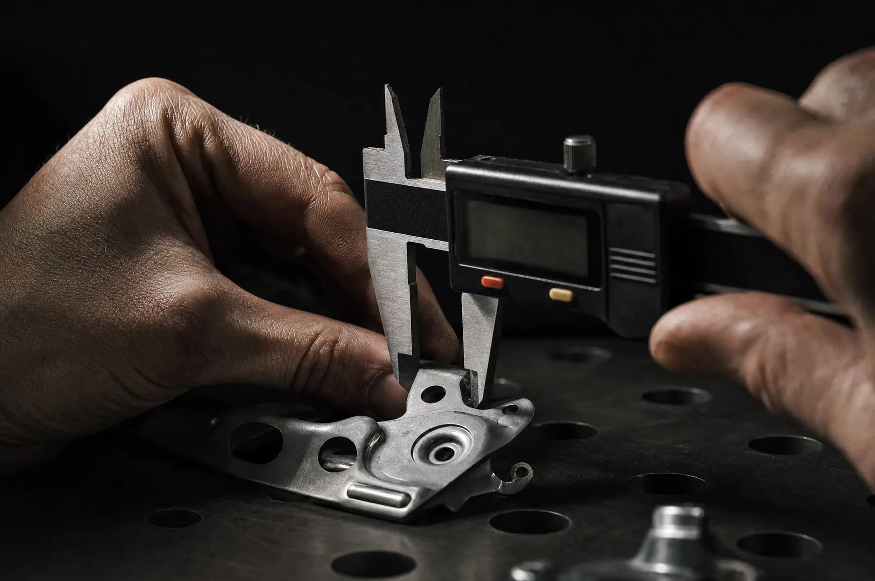 Finished parts laid out on a bench under inspection light